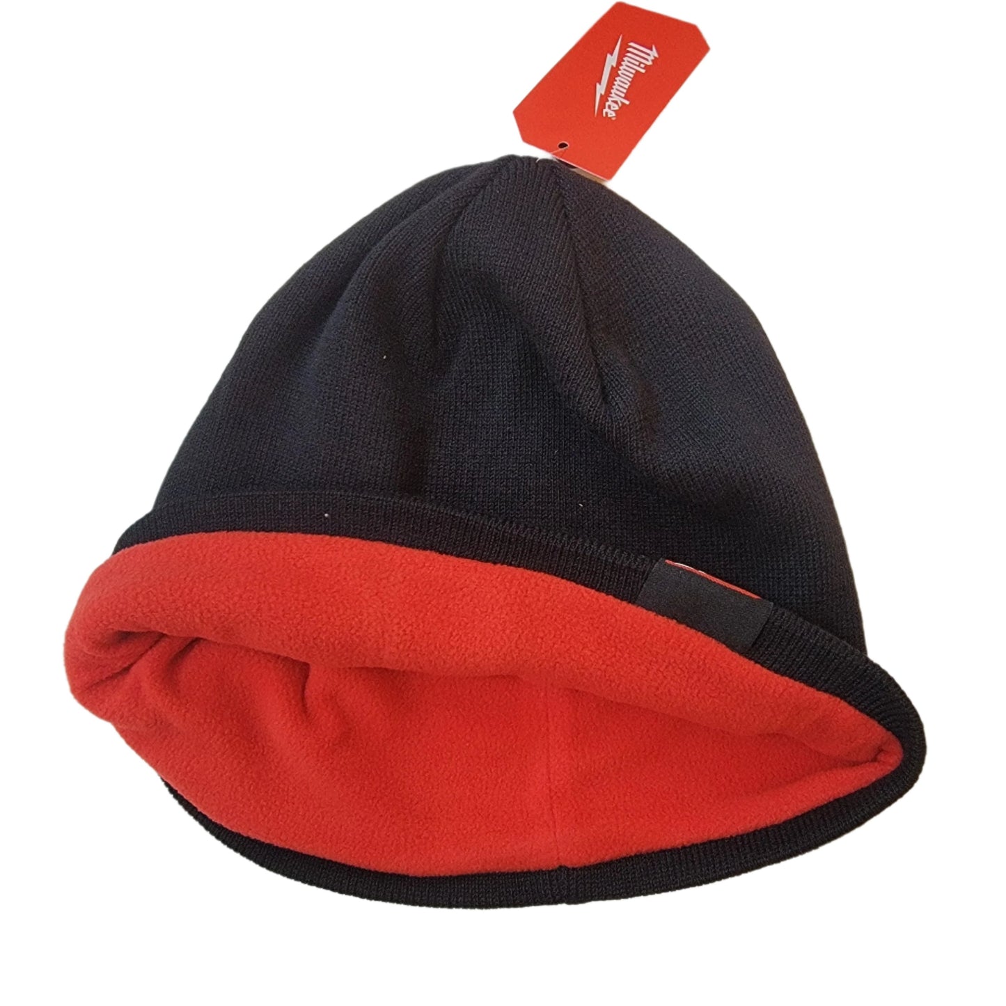 The Milwaukee Beanie Hat showcases a snug red fleece lining and a vibrant red brand tag on top of its black winter knit design, adding a pop of color to your cold-weather attire.