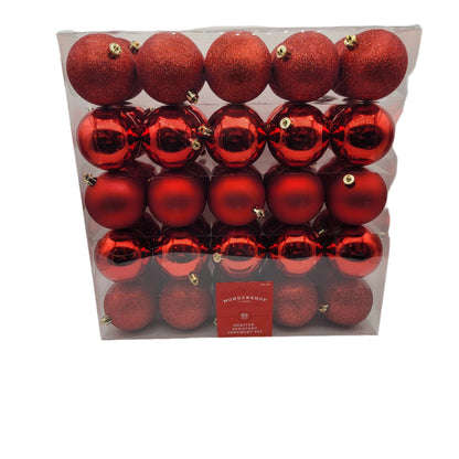 A set of shatter-resistant, red Christmas ornaments in shiny, matte, and glitter finishes, packaged in a plastic container.