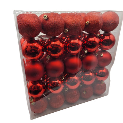 A shatter-resistant ornament set featuring multiple red bulbs with both shiny and matte finishes, housed in a clear plastic box.