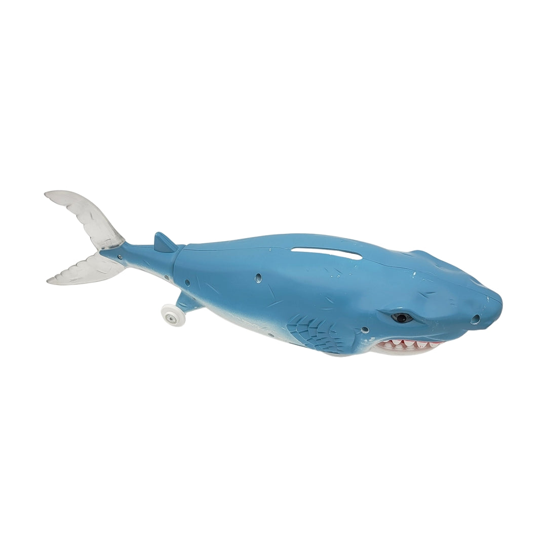 The Bump n Go Shark is a toy with a blue body, a white underbelly, wheels, and a visible battery compartment on its side.