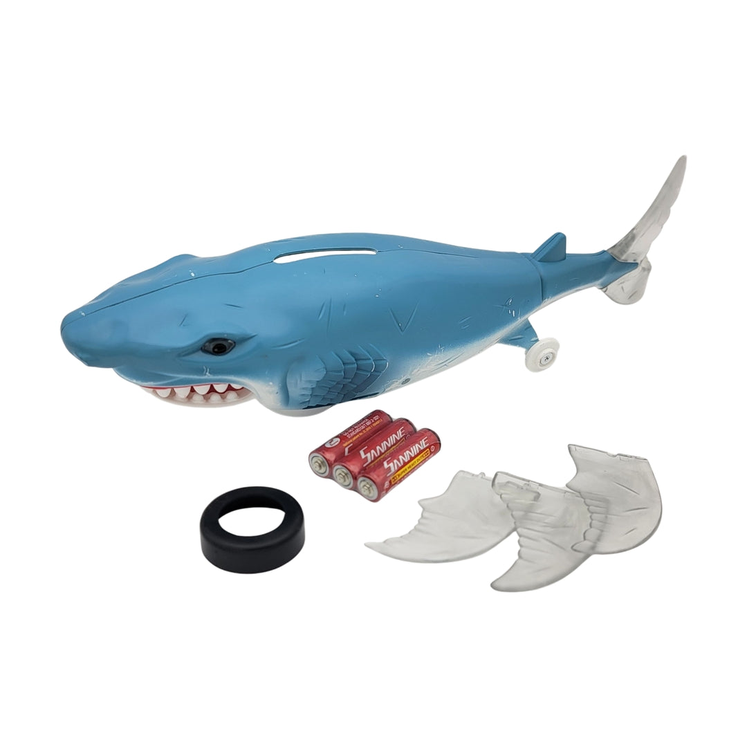 Bump n go shark featuring detachable fins, a black ring, and powered by four AA batteries.