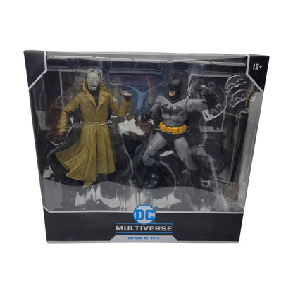 This package contains two action figures from the DC Multiverse line, showcasing Batman in a gray suit and Hush in a trench coat. It is labeled "Multiverse Batman VS Hush" and is suitable for ages 12 and up.