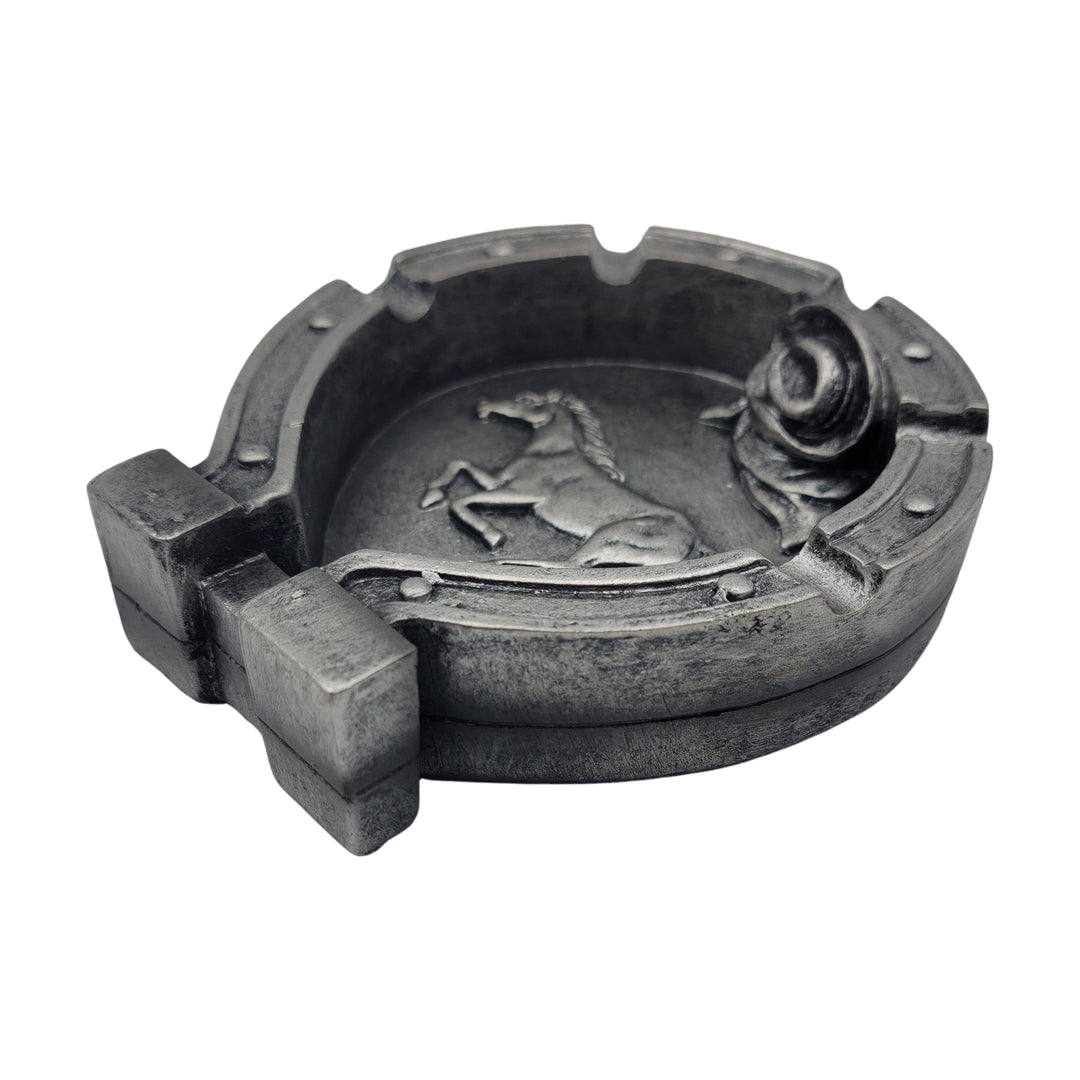 Introducing the "Wild Stallion Ash Trash Horse Decor," a metal ashtray meticulously designed in the shape of a horseshoe and adorned with a raised horse motif on its surface.