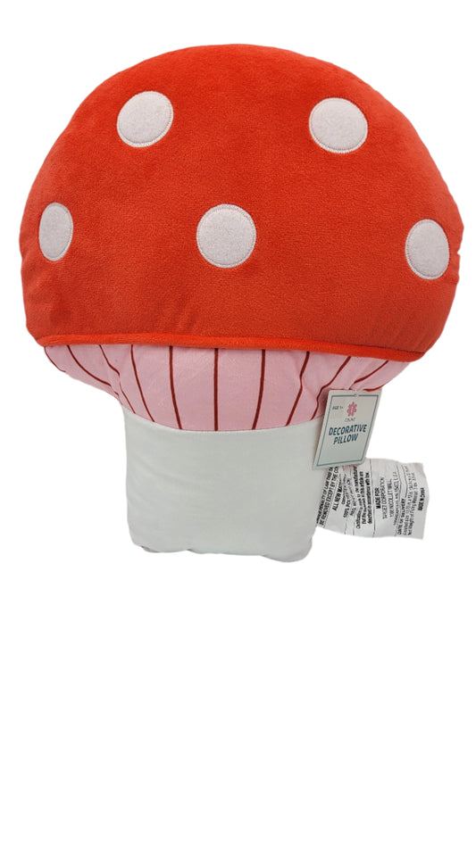 A Cute Mushroom Decorative Pillow featuring a red top with white polka dots, a pink stem with red lines, and attached tags.