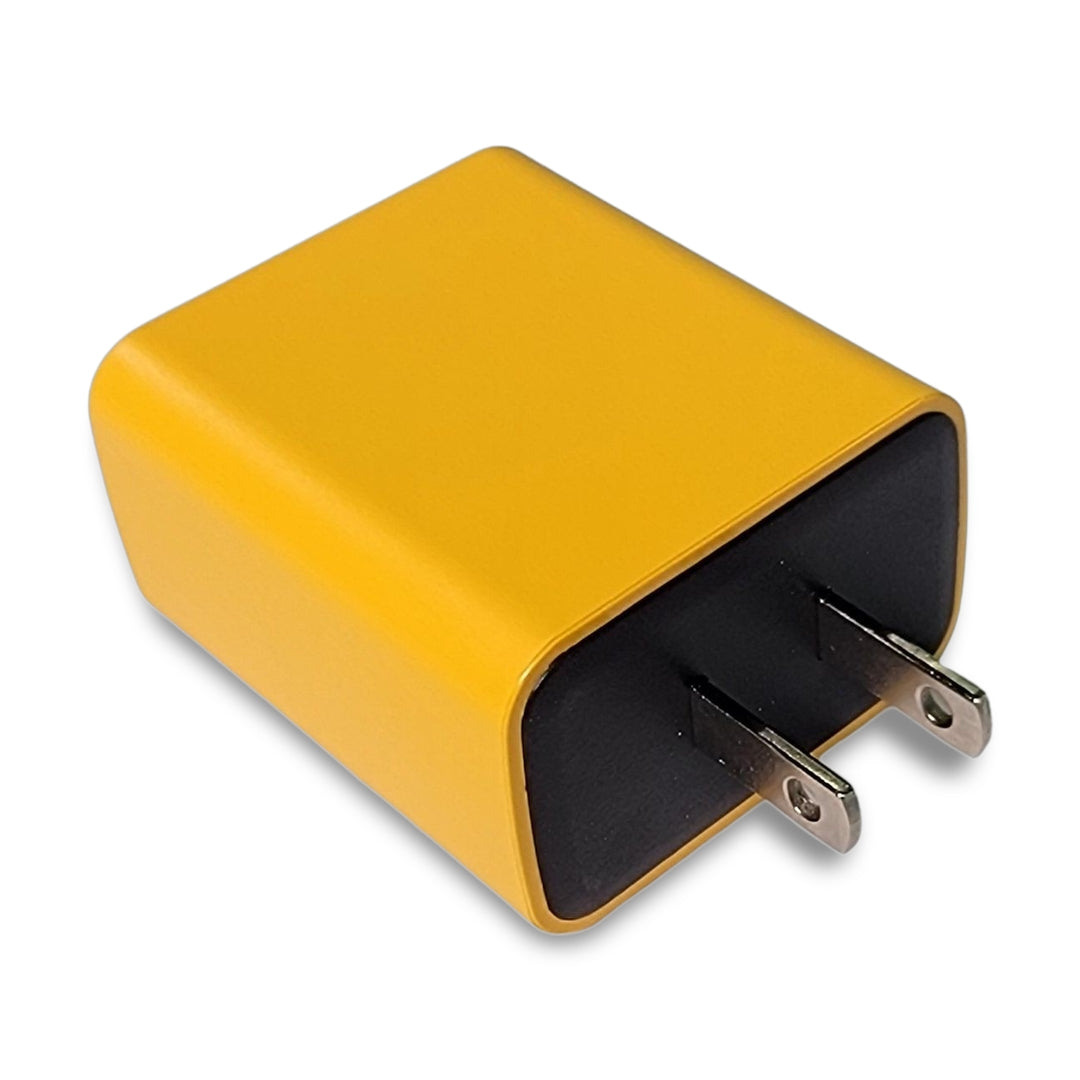 Yellow 3 Ports 65W Fast Charger, featuring a black front and two prongs, shown in an angled view. Perfect for safely charging devices, crafted with flame-retardant material.