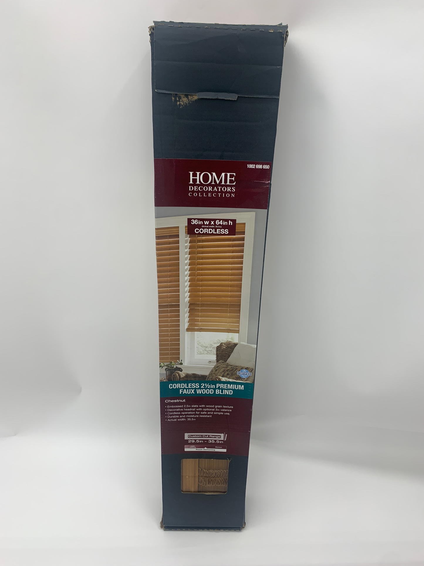 A box labeled "Home Decorators Collection Chestnut 2.5-inch Premium Faux Wood Blinds-36x64" with a photo of the blinds on the packaging.