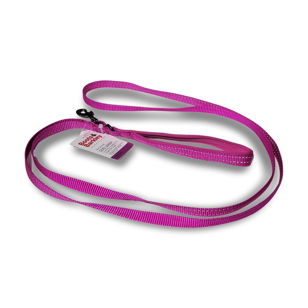 A pink Boots & Barkley reflective dog leash, ideal for dogs weighing up to 25lbs, lies coiled on a white background. It features a black clip and an attached tag and measures 6ft in length, providing both comfort and control during walks.