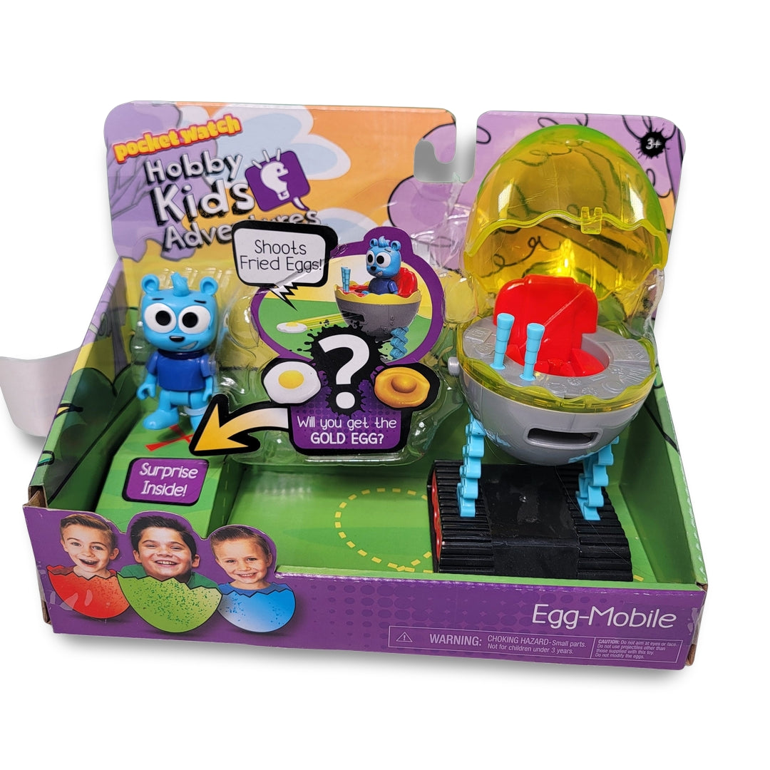 Hobby Kids Action Figures toy set includes a blue character, a yellow egg-shaped container, and an Egg-Mobile. The packaging teases a surprise and questions if the gold egg will be found.