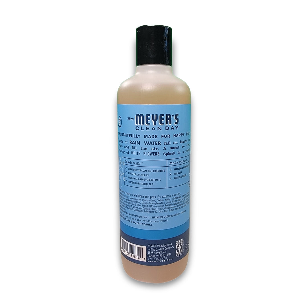 A bottle of mrs meyer body wash with a blue label featuring product details and usage instructions.