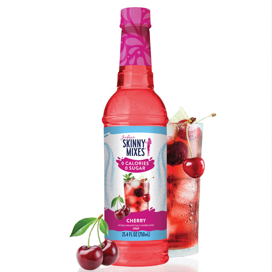 A bottle of Jordan's Skinny Syrup Cherry, Sugar Free, 25.4 oz., with cherries and a cherry drink in a glass filled with ice cubes.