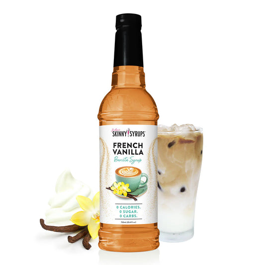 A bottle of Jordan's Skinny Syrup French Vanilla, Sugar Free, 25.4oz next to an iced coffee. The syrup label displays '0 Calories, 0 Sugar, 0 Carbs.' A vanilla flower and beans are also depicted beside the bottle.