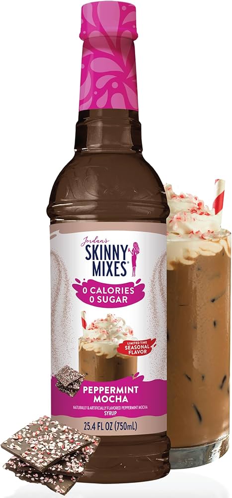 A bottle of Skinny Syrup Peppermint Mocha, Sugar Free, 25.4 oz, beside a glass of iced mocha topped with whipped cream and peppermint shavings.